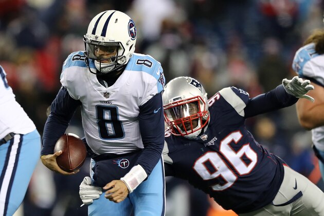 FOXBOROUGH, MA - JANUARY 13:  Marcus Mariota #8 of the Tennessee Titans is tackled by Geneo Grissom #96 of the New England Patriots during the fourth quarter in the AFC Divisional Playoff game at Gillette Stadium on January 13, 2018 in Foxborough, Massachusetts.  (Photo by Elsa/Getty Images)
