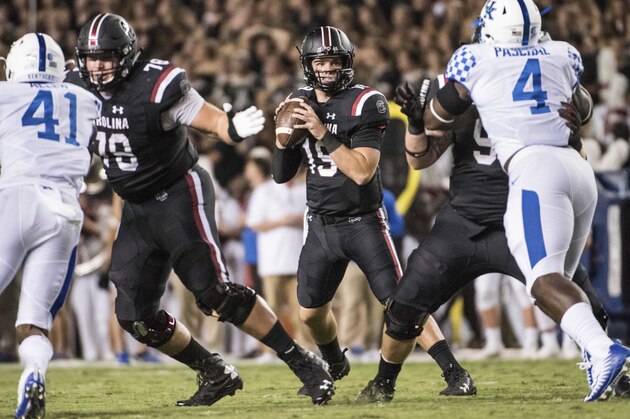 South Carolina quarterback Jake Bentley (19) looks for a passing lane against pressure from Kentucky linebackers Josh Allen (41) and Joshua Paschal (4) during the first half of an NCAA college football game Saturday, Sept. 16, 2017, in Columbia, S.C. Kentucky defeated South Carolina 23-13. (AP Photo/Sean Rayford)
