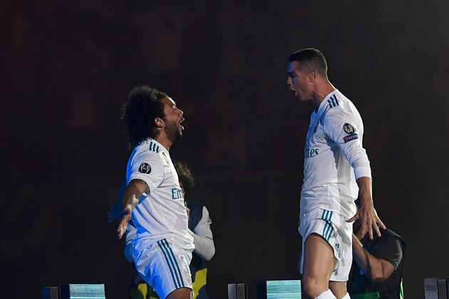Real Madrid's Brazilian defender Marcelo (L) and Real Madrid's Portuguese forward Cristiano Ronaldo celebrate at the Santiago Bernabeu stadium in Madrid on May 27, 2018 during a victory ceremony after Real Madrid won its third Champions League title in a row in Kiev. (Photo by OSCAR DEL POZO / AFP)        (Photo credit should read OSCAR DEL POZO/AFP/Getty Images)