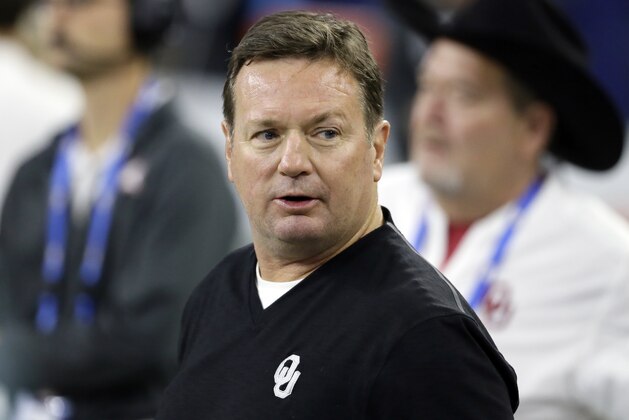 Former Oklahoma head coach Bob Stoops stands on the field watching the celebration after Oklahoma's win in the Big 12 Conference championship NCAA college football game against TCU on Saturday, Dec. 2, 2017, in Arlington, Texas. (AP Photo/Tony Gutierrez)