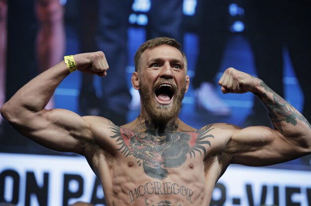Conor McGregor poses on the scale during a weigh-in Friday, Aug. 25, 2017, in Las Vegas. McGregor is scheduled to fight Floyd Mayweather Jr. in a boxing bout Saturday (AP Photo/John Locher)