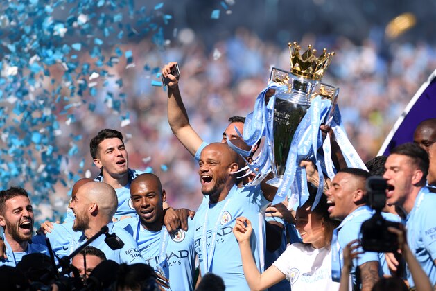 MANCHESTER, ENGLAND - MAY 06:  Vincent Kompany of Manchester City lifts the Premier League Trophy as Manchester City celebrate winning the Premier League after the Premier League match between Manchester City and Huddersfield Town at Etihad Stadium on May 6, 2018 in Manchester, England.  (Photo by Laurence Griffiths/Getty Images)