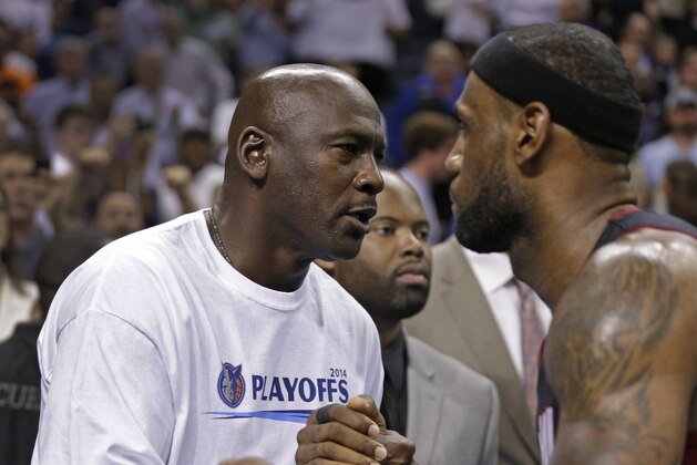 Charlotte Bobcats owner Michael Jordan, left, shakes hands with Miami Heat's LeBron James, right, after Game 4 of an opening-round NBA basketball playoff series in Charlotte, N.C., Monday, April 28, 2014. The Heat won 109-98, sweeping the series. (AP Photo/Chuck Burton)