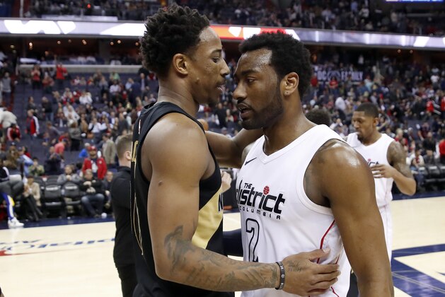 Toronto Raptors guard DeMar DeRozan, left, talks with Washington Wizards guard John Wall (2) after Game 6 of an NBA basketball first-round playoff series Friday, April 27, 2018, in Washington. The Raptors won 102-92, and won the series. (AP Photo/Alex Brandon)