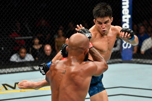 LOS ANGELES, CA - AUGUST 04:  (R-L) Henry Cejudo kicks Demetrious Johnson in their UFC flyweight championship fight during the UFC 227 event inside Staples Center on August 4, 2018 in Los Angeles, California. (Photo by Jeff Bottari/Zuffa LLC/Zuffa LLC via Getty Images)