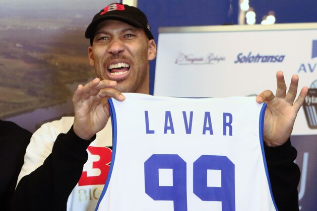 Los Angeles entrepreneur LaVar Ball holds up a jersey a press conference in Prienai, Lithuania, where his sons LaMelo Ball, LiAngelo Ball will play for the Vytautas club on January 5, 2018.
Basketball-crazed Lithuania welcomed LiAngelo and LaMelo Ball, the two youngest sons of flamboyant Los Angeles entrepreneur LaVar Ball who recently made headlines due to a feud with US President Donald Trump. / AFP PHOTO / Petras Malukas        (Photo credit should read PETRAS MALUKAS/AFP/Getty Images)