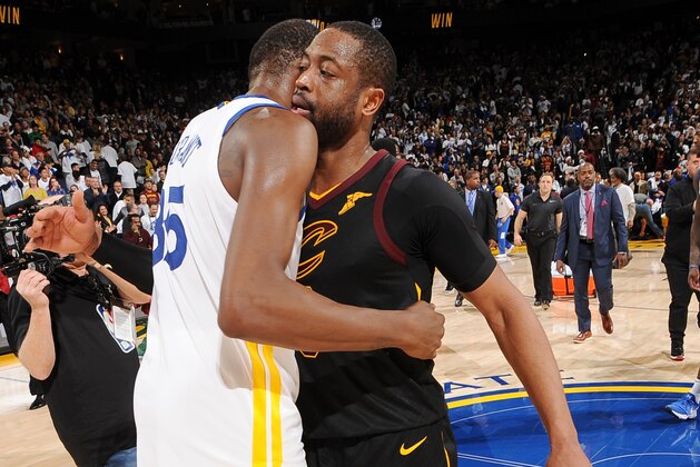 OAKLAND, CA - DECEMBER 25:  Kevin Durant #35 of the Golden State Warriors exchange a hug with Dwyane Wade #9 of the Cleveland Cavaliers after the game between the two teams on December 25, 2017 at ORACLE Arena in Oakland, California. NOTE TO USER: User expressly acknowledges and agrees that, by downloading and or using this photograph, user is consenting to the terms and conditions of Getty Images License Agreement. Mandatory Copyright Notice: Copyright 2017 NBAE (Photo by Noah Graham/NBAE via Getty Images)