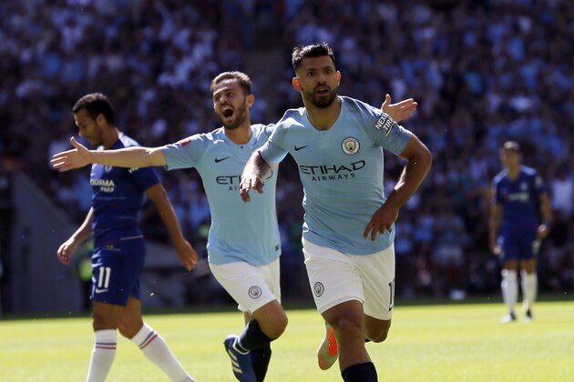 Manchester City's Sergio Aguero, front, celebrates scoring the first goal the game during the Community Shield soccer match between Chelsea and Manchester City at Wembley, London, Sunday, Aug. 5, 2018. (AP Photo/Tim Ireland)