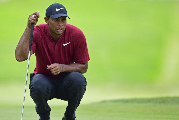 Tiger Woods examines the green on the fifth hole during the final round of the Bridgestone Invitational golf tournament at Firestone Country Club, Sunday, Aug. 5, 2018, in Akron, Ohio. (AP Photo/David Dermer)