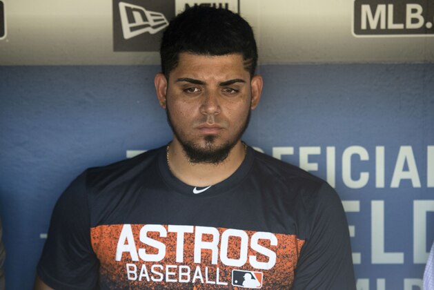 Houston Astros relief pitcher Roberto Osuna is interviewed in the dugout before a baseball game against the Los Angeles Dodgers in Los Angeles, Sunday, Aug. 5, 2018. Osuna served a 75-game suspension for violating Major League Baseball's domestic violence policy. (AP Photo/Kyusung Gong)