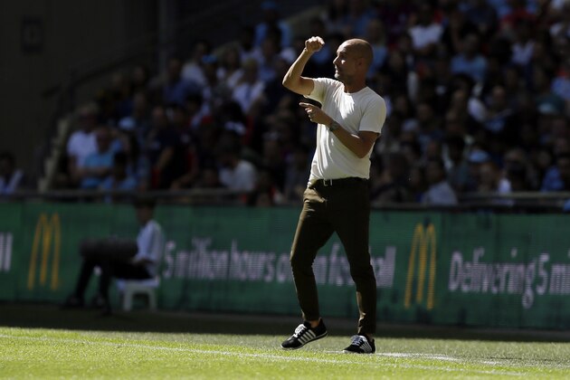 Manchester City's manager Pep Guardiola gives instructions from the sidelines during the Community Shield soccer match between Chelsea and Manchester City at Wembley, London, Sunday, Aug. 5, 2018. (AP Photo/Tim Ireland)