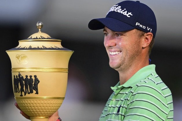 Justin Thomas holds the Gary Player Cup trophy after winning the final round of the Bridgestone Invitational golf tournament at Firestone Country Club, Sunday, Aug. 5, 2018, in Akron, Ohio. (AP Photo/David Dermer)
