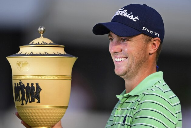 Justin Thomas holds the Gary Player Cup trophy after winning the final round of the Bridgestone Invitational golf tournament at Firestone Country Club, Sunday, Aug. 5, 2018, in Akron, Ohio. (AP Photo/David Dermer)