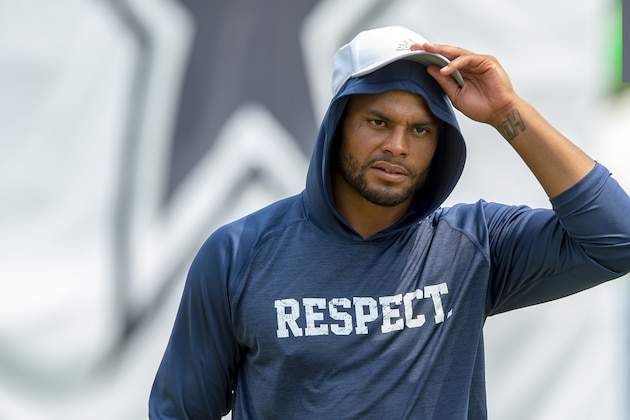 Dallas Cowboys quarterback Dak Prescott walks off the field after morning practice during NFL football training camp, Saturday, July 28, 2018, in Oxnard, Calif. (AP Photo/Gus Ruelas)