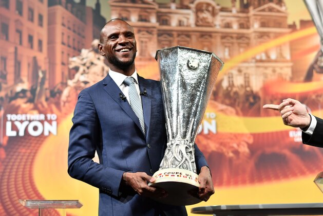 TOPSHOT - Former French football player and ambassador for the UEFA Europa League final in Lyon, Eric Abidal poses after the handover of the trophy following the draw for the semi-finals round of the UEFA Europa League football tournament at the UEFA headquarters in Nyon on April 13, 2018.  / AFP PHOTO / Fabrice COFFRINI        (Photo credit should read FABRICE COFFRINI/AFP/Getty Images)