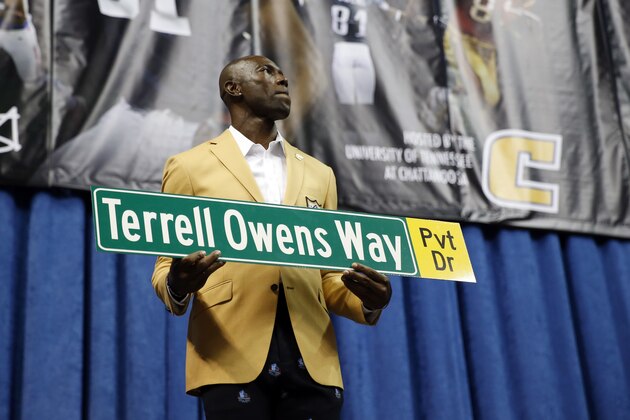 Former wide receiver Terrell Owens holds a street sign after a road was named after him following his NFL Pro Football Hall of Fame speech on Saturday, Aug. 4, 2018, in Chattanooga, Tenn. Instead of speaking at the Hall of Fame festivities in Canton, Ohio, Owens celebrated his induction at the University of Tennessee at Chattanooga, where he played football and basketball and ran track. (AP Photo/Mark Humphrey)