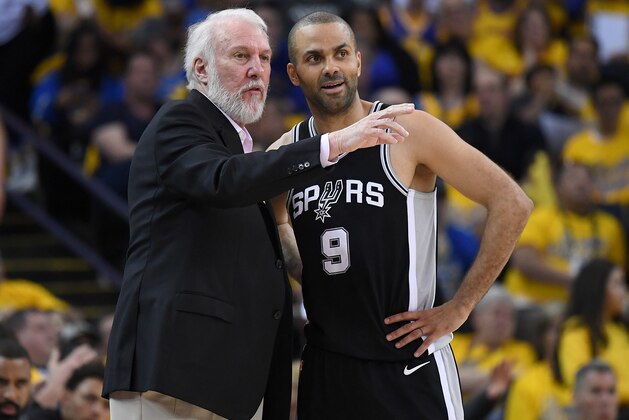 OAKLAND, CA - APRIL 14:  Head coach Gregg Popovich of the San Antonio Spurs talks with his player Tony Parker #9 against the Golden State Warriors in the second quarter during Game One of the first round of the 2018 NBA Playoff at ORACLE Arena on April 14, 2018 in Oakland, California. NOTE TO USER: User expressly acknowledges and agrees that, by downloading and or using this photograph, User is consenting to the terms and conditions of the Getty Images License Agreement.  (Photo by Thearon W. Henderson/Getty Images)