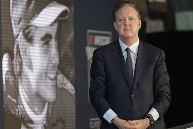 NASCAR Chairman Brian France watches a video of driver Jeff Gordon after after announcing Gordon will be inducted into the 2019 class of the NASCAR Hall of Fame, in Charlotte, N.C., Wednesday, May 23, 2018. (AP Photo/Chuck Burton)