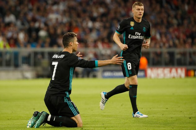 Real Madrid's Portuguese forward Cristiano Ronaldo (L) reacts after a challange next to Real Madrid's German midfielder Toni Kroos during the UEFA Champions League semi-final first-leg football match FC Bayern Munich v Real Madrid CF in Munich, southern Germany on April 25, 2018. (Photo by Odd ANDERSEN / AFP)        (Photo credit should read ODD ANDERSEN/AFP/Getty Images)