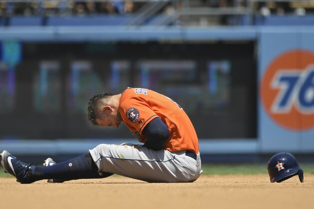 LOS ANGELES, CA - AUGUST 05: George Springer #4 of the Houston Astros reacts to being injured after getting caught trying to steal second base in the third inning against the Los Angeles Dodgers at Dodger Stadium on August 5, 2018 in Los Angeles, California. (Photo by John McCoy/Getty Images)