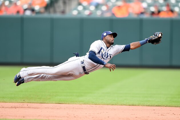 BALTIMORE, MD - JULY 29:  Adeiny Hechavarria #11 of the Tampa Bay Rays dives after a hit by Mark Trumbo #45 of the Baltimore Orioles in the eight inning during a baseball game at Oriole Park at Camden Yards on July 29, 2018 in Baltimore, Maryland.  (Photo by Mitchell Layton/Getty Images)