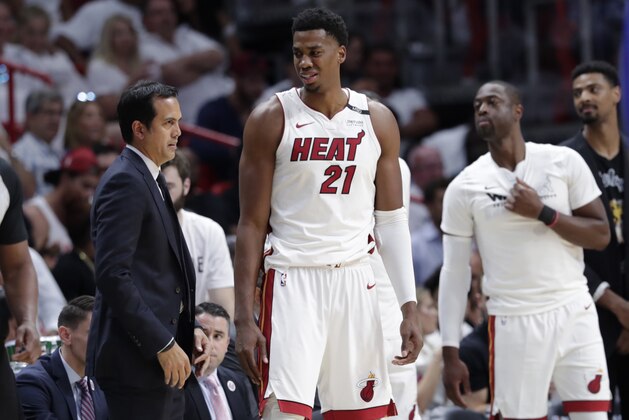 Miami Heat's Hassan Whiteside (21) stands on the sidelines with head coach Erik Spoelstra, left, during the second half of Game 3 of a first-round NBA basketball playoff series against the Philadelphia 76ers, Thursday, April 19, 2018, in Miami. The 76ers won 128-108. (AP Photo/Lynne Sladky)