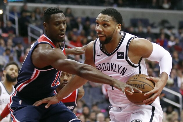 Washington Wizards center Ian Mahinmi (28), from France, guards Brooklyn Nets center Jahlil Okafor (4) during the first half of an NBA basketball game Saturday, Jan. 13, 2018, in Washington. (AP Photo/Alex Brandon)