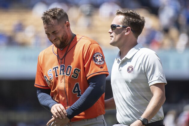 Houston Astros' George Springer, left, exits with a trainer after getting injured whiletrying to steal second base during the third inning of a baseball game against the Los Angeles Dodgers in Los Angeles, Sunday, Aug. 5, 2018. (AP Photo/Kyusung Gong)
