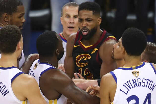 Cleveland Cavaliers center Tristan Thompson, facing, confronts Golden State Warriors forward Draymond Green, second from bottom left, during overtime of Game 1 of basketball's NBA Finals in Oakland, Calif., Thursday, May 31, 2018. The Warriors won 124-114. (AP Photo/Ben Margot)