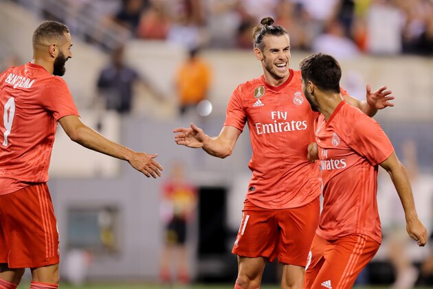 EAST RUTHERFORD, NJ - AUGUST 07:  Gareth Bale #11 of Real Madrid celebrates with Karim Benzema #9, and Marco Asensio #20 after scoring a goal in the 15th minute against Robin Olsen #1 of Roma during the first half of the International Champions Cup match at MetLife Stadium on August 7, 2018 in East Rutherford, New Jersey.  (Photo by Elsa/International Champions Cup/Getty Images)
