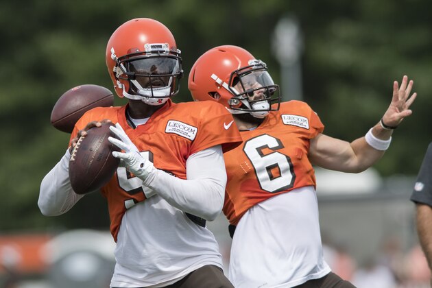 Cleveland Browns quarterbacks Tyrod Taylor, left, and Baker Mayfield throw passes during NFL football training camp Thursday, Aug. 2, 2018, in Berea, Ohio. (AP Photo/Ken Blaze)