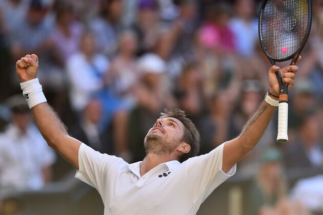 Switzerland's Stan Wawrinka celebrates after beating Bulgaria's Grigor Dimitrov 6-1, 7-6, 7-6, 6-4 in their men's singles first round match on the first day of the 2018 Wimbledon Championships at The All England Lawn Tennis Club in Wimbledon, southwest London, on July 2, 2018. (Photo by Glyn KIRK / AFP) / RESTRICTED TO EDITORIAL USE        (Photo credit should read GLYN KIRK/AFP/Getty Images)