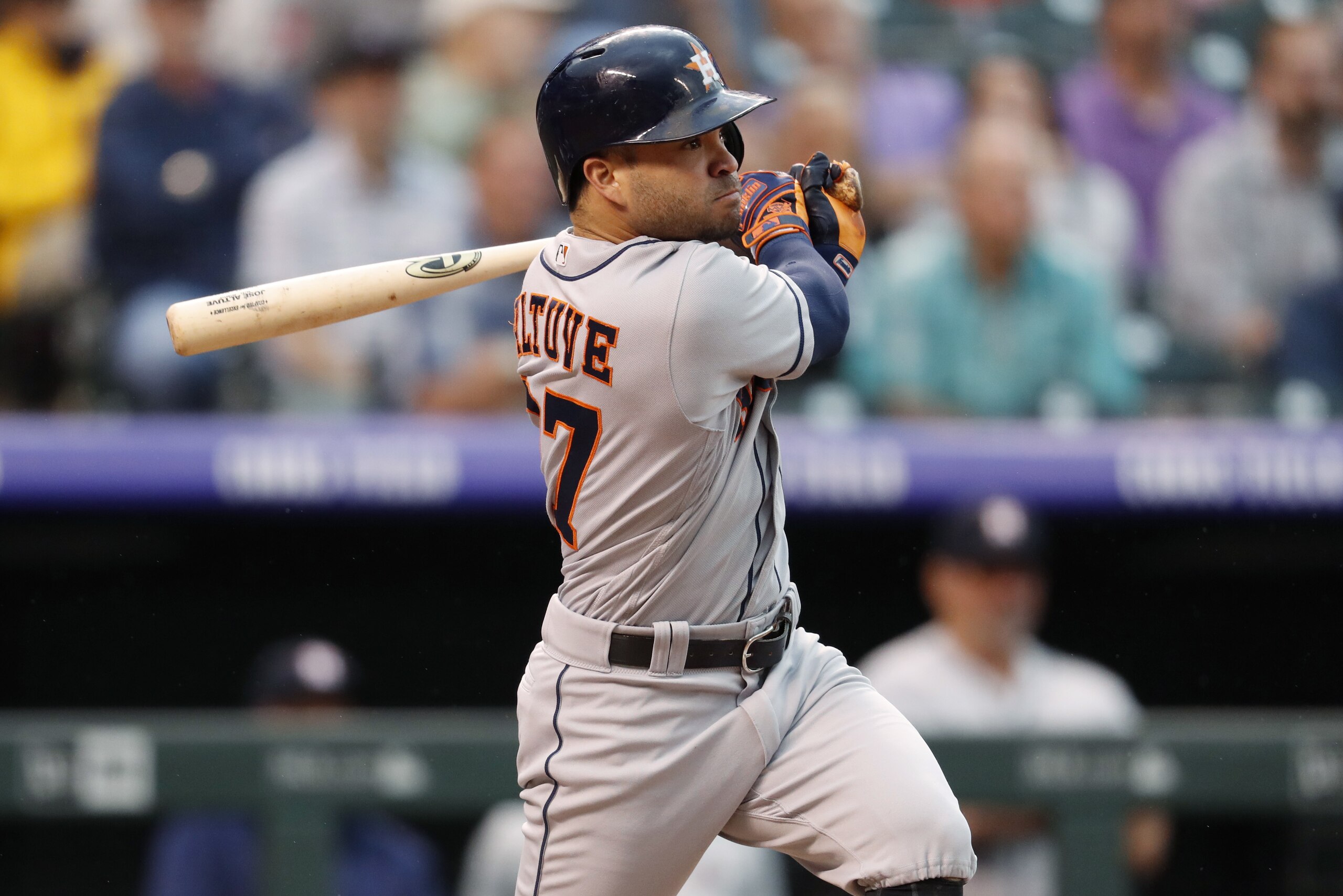 Houston Astros' Jose Altuve watches his RBI-double off Colorado Rockies starting pitcher Jon Gray during the fourth inning of a baseball game Wednesday, July 25, 2018, in Denver. (AP Photo/David Zalubowski)