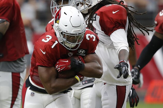 Arizona Cardinals running back David Johnson (31) runs with the ball next to defensive back Tre Boston, right, during an NFL football practice Saturday, Aug. 4, 2018, in Glendale, Ariz. (AP Photo/Ross D. Franklin)