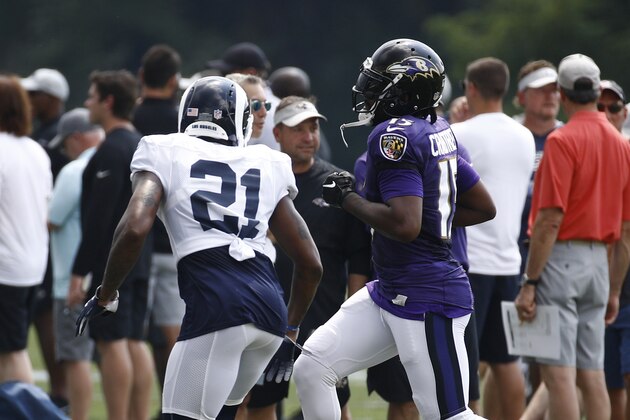 Los Angeles Rams cornerback Aqib Talib, left, defends Baltimore Ravens wide receiver Michael Crabtree during a joint NFL football training camp practice at the Raven's headquarters, Monday, Aug. 6, 2018, in Owings Mills, Md. (AP Photo/Patrick Semansky)