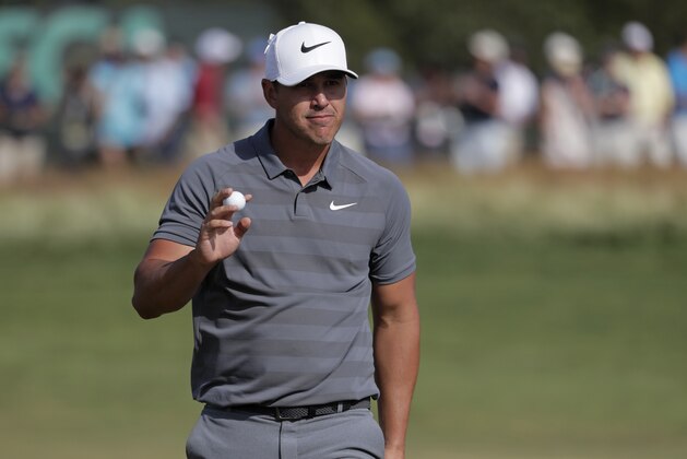 Brooks Koepka reacts after putting on the 12th green during the final round of the U.S. Open Golf Championship, Sunday, June 17, 2018, in Southampton, N.Y. (AP Photo/Julio Cortez)