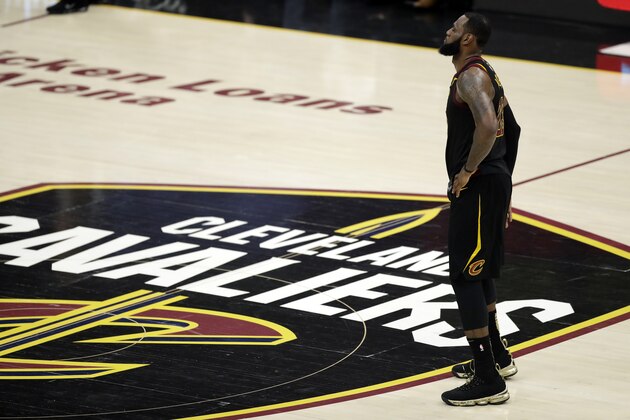 FILE - In this June 8, 2018, file photo, Cleveland Cavaliers' LeBron James watches during the first half of Game 4 of basketball's NBA Finals against the Golden State Warriors, in Cleveland. James has until June 29 to exercise his $35.6 million contract option for next season or decline it and become an unrestricted free agent, officially making him the planet’s best and most coveted player. The 33-year-old is not expected to reveal his intentions until after the draft. (AP Photo/Tony Dejak, File)