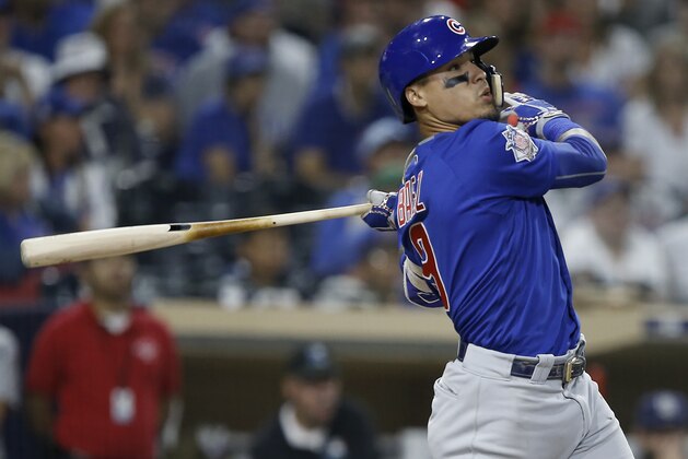 Chicago Cubs' Javier Baez follows through on a three-run home run against the San Diego Padres during the ninth inning of a baseball game in San Diego, Saturday, July 14, 2018. (AP Photo/Alex Gallardo)