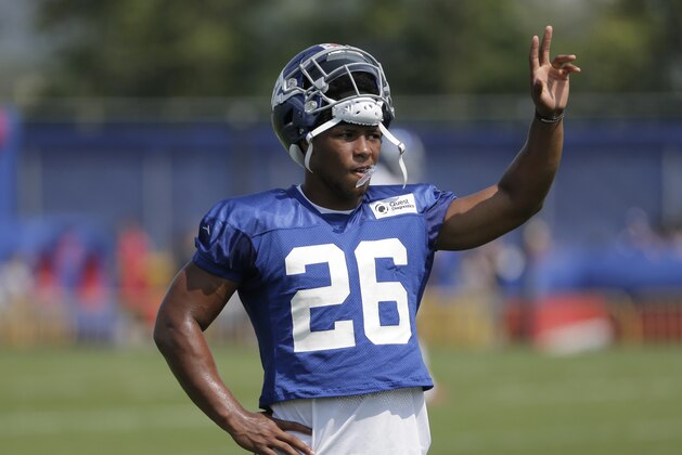 New York Giants' Saquon Barkley waves to fans during NFL football training camp in East Rutherford, N.J., Tuesday, Aug. 7, 2018. (AP Photo/Seth Wenig)