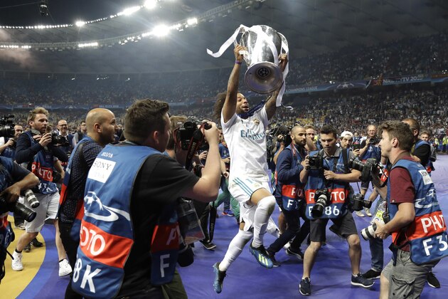 Real Madrid's Marcelo celebrates with the trophy after winning the Champions League Final soccer match between Real Madrid and Liverpool at the Olimpiyskiy Stadium in Kiev, Ukraine, Saturday, May 26, 2018. (AP Photo/Matthias Schrader)