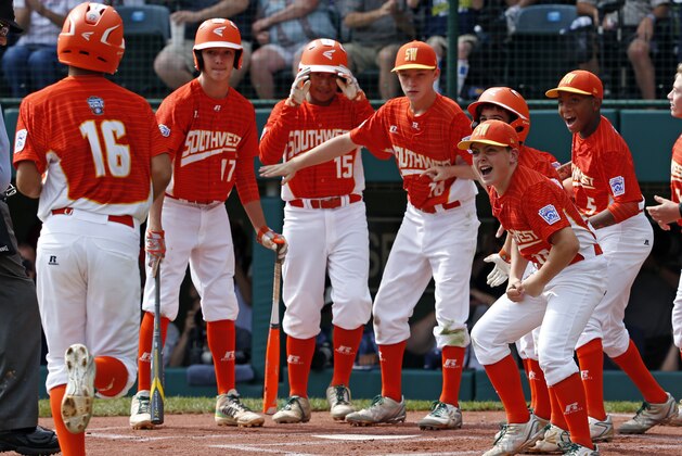 Lufkin, Texas' Hunter Ditsworth (16) is greeted by teammates after hitting a solo home run off Japan's Tsubasa Tomii in the first inning of the Little League World Series Championship baseball game in South Williamsport, Pa., Sunday, Aug. 27, 2017. (AP Photo/Gene J. Puskar).