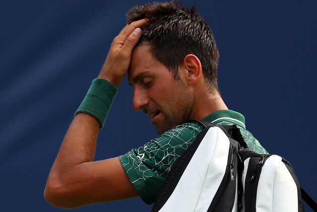 TORONTO, ON - AUGUST 09:  Novak Djokovic of Serbia walks off the court after being defeated by Stefanos Tsitsipas of Greece during a 3rd round match on Day 4 of the Rogers Cup at Aviva Centre on August 9, 2018 in Toronto, Canada.  (Photo by Vaughn Ridley/Getty Images)