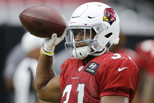 Arizona Cardinals running back David Johnson tosses the ball to a coach during an NFL football practice, Thursday, Aug. 2, 2018, in Glendale, Ariz. (AP Photo/Ross D. Franklin)