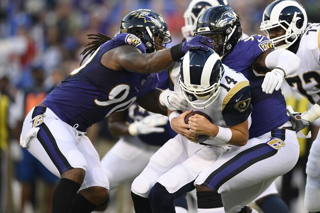 Los Angeles Rams quarterback Sean Mannion (14) is sacked by Baltimore Ravens linebackers Za'Darius Smith, left, and linebacker Matt Judon in the first half of a preseason NFL football game, Thursday, Aug. 9, 2018, in Baltimore. (AP Photo/Nick Wass)