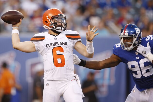 Cleveland Browns quarterback Baker Mayfield (6) throws a pass away from New York Giants' Kareem Martin (96) during the first half of a preseason NFL football game Thursday, Aug. 9, 2018, in East Rutherford, N.J. (AP Photo/Adam Hunger)