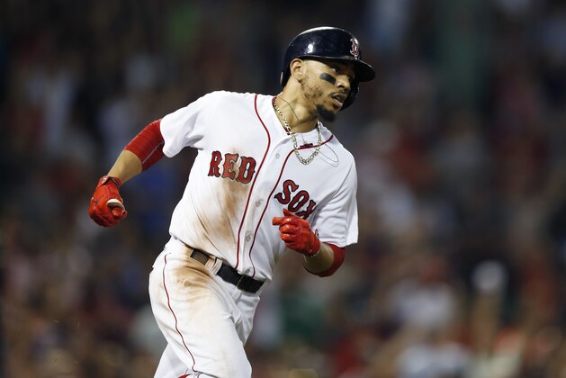 Boston Red Sox's Mookie Betts rounds first base on his solo home run during the fifth inning of a baseball game against the New York Yankees in Boston, Sunday, Aug. 5, 2018. (AP Photo/Michael Dwyer)