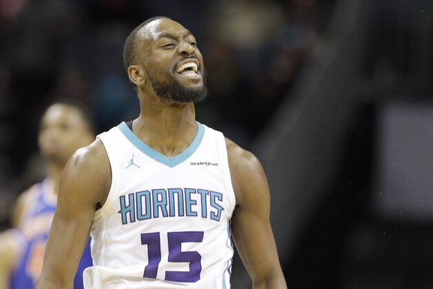 Charlotte Hornets' Kemba Walker (15) reacts after making a 3-point basket against the New York Knicks during overtime of an NBA basketball game in Charlotte, N.C., Monday, March 26, 2018. (AP Photo/Chuck Burton)