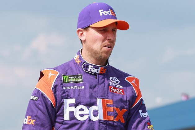 BROOKLYN, MI - AUGUST 10:  Denny Hamlin, driver of the #11 FedEx Office Toyota, walks to his car during qualifying for the Monster Energy NASCAR Cup Series Consmers Energy 400 at Michigan International Speedway on August 10, 2018 in Brooklyn, Michigan.  (Photo by Matt Sullivan/Getty Images)