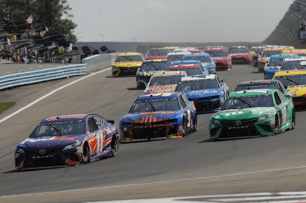 Denny Hamlin (11), Chase Elliott (9) and Kyle Busch (18) lead the pack into turn one at the start of a NASCAR Cup series auto race, Sunday, Aug. 5, 2018, in Watkins Glen, N.Y. (AP Photo/Julie Jacobson)