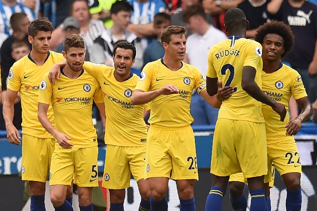 Chelsea's Italian midfielder Jorginho (2L) celebrates with teammates after scoring a penalty and the team's second goal during the English Premier League football match between Huddersfield Town and Chelsea at the John Smith's stadium in Huddersfield, northern England on August 11, 2018. (Photo by Oli SCARFF / AFP) / RESTRICTED TO EDITORIAL USE.No use with unauthorized audio, video, data, fixture lists, club/league logos or 'live' services. Online in-match use limited to 120 images. An additional 40 images may be used in extra time. No video emulation. Social media in-match use limited to 120 images. An additional 40 images may be used in extra time. No use in betting publications, games or single club/league/player publications/ /         (Photo credit should read OLI SCARFF/AFP/Getty Images)